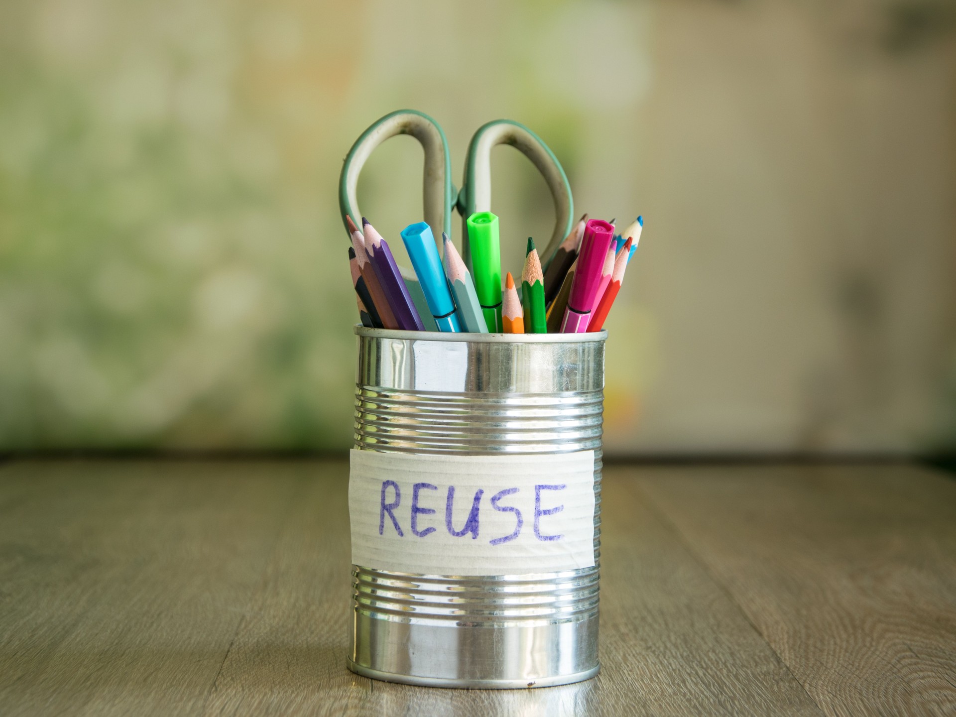 Lettering reuse glued on can filled stationery on blurred background