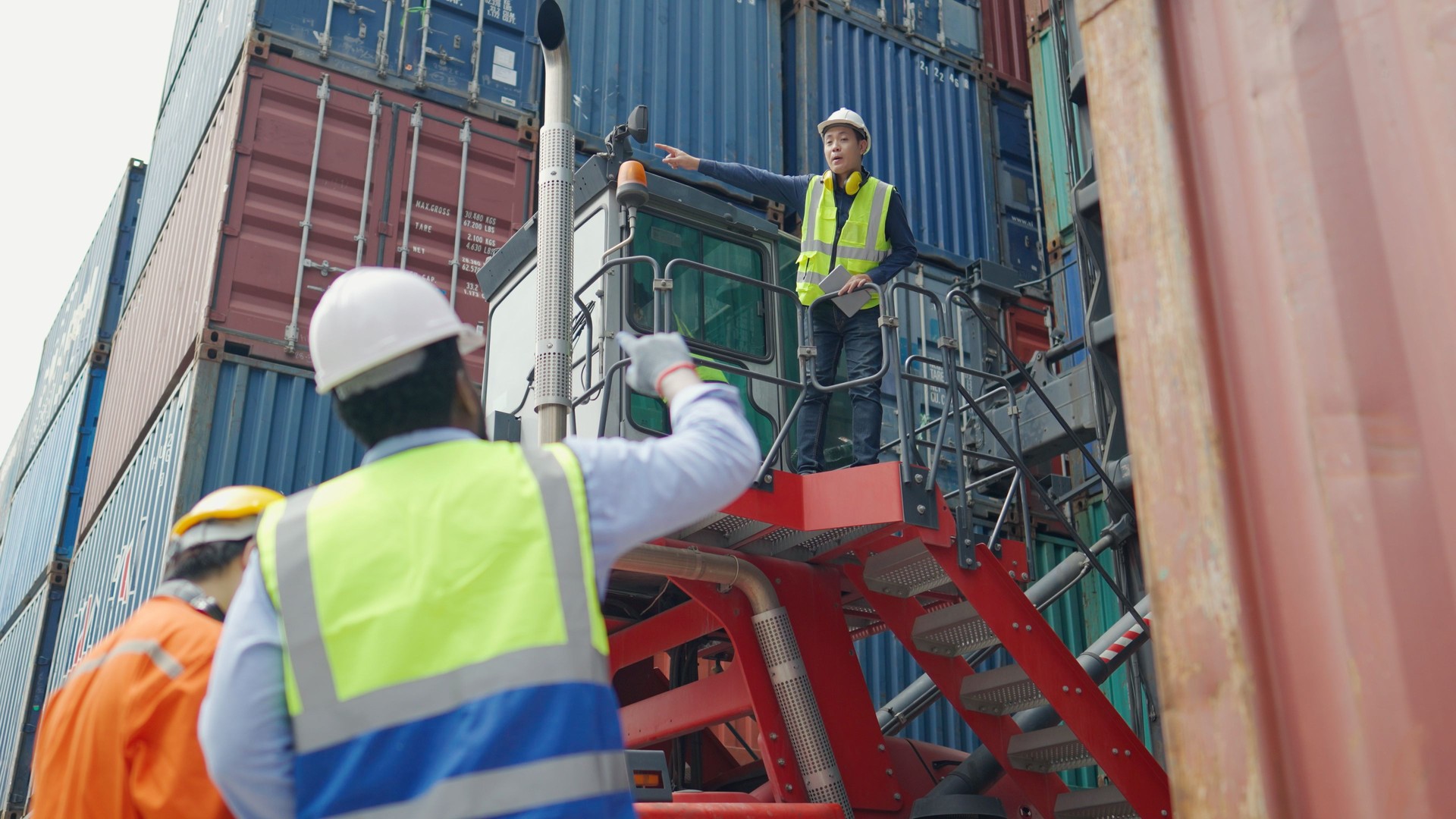 A group of technicians and engineers are inspecting a large number of containers.